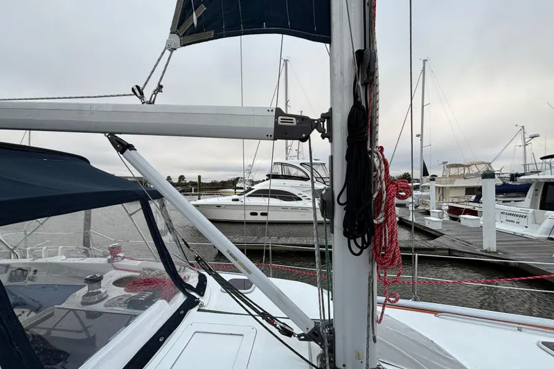 Slide: The Image of Hunter Passage 450 sailboat from 2000 docked at a marina, featuring rigging and sails. - 9