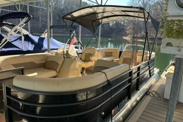 The Image of 2019 Crest 220 CREST II pontoon boat docked on a serene lake. - 1