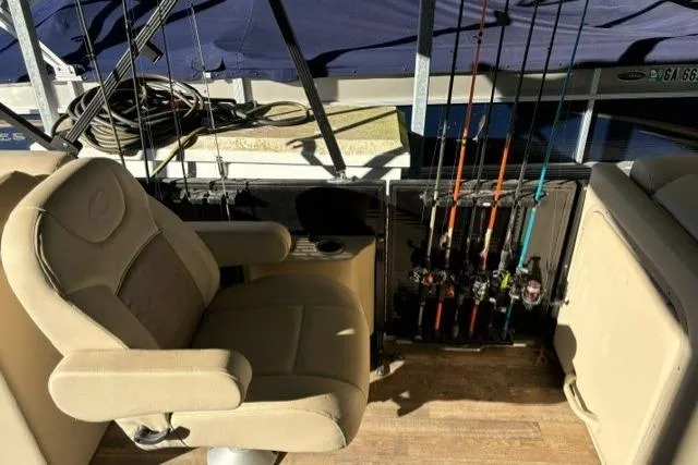Slide: The Image of 2019 Crest 220 CREST II boat interior with fishing rods and captain's chair. - 10