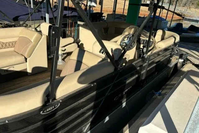 Slide: The Image of 2019 Crest 220 CREST II pontoon boat with beige seating and black exterior. - 15