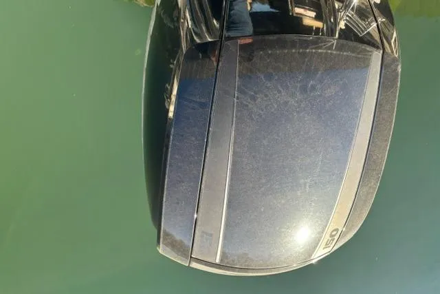 Slide: The Image of Outboard motor on a 2019 Crest 220 CREST II boat, reflecting sunlight on water. - 19
