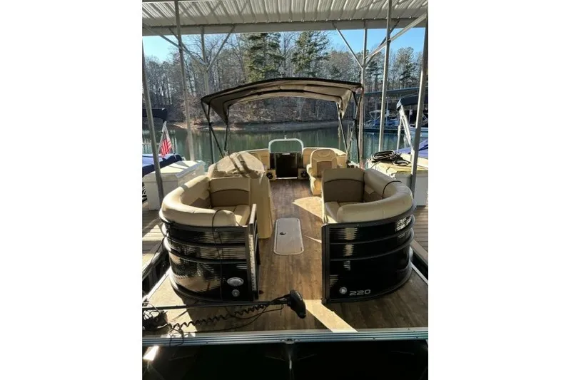 Slide: The Image of 2019 Crest 220 CREST II pontoon boat docked under a canopy. - 4