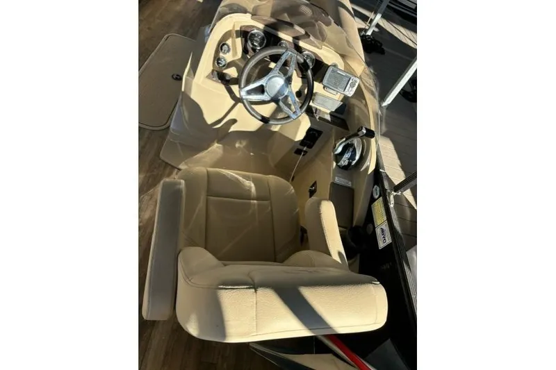 Slide: The Image of 2019 Crest 220 CREST II boat interior with steering wheel and beige seating. - 6