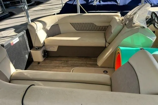 Slide: The Image of 2019 Crest 220 CREST II boat interior with beige seating and wood flooring. - 8