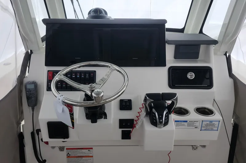 Slide: The Image of 2026 Pursuit S 288 Sport boat interior compartment with mechanical components. - 11