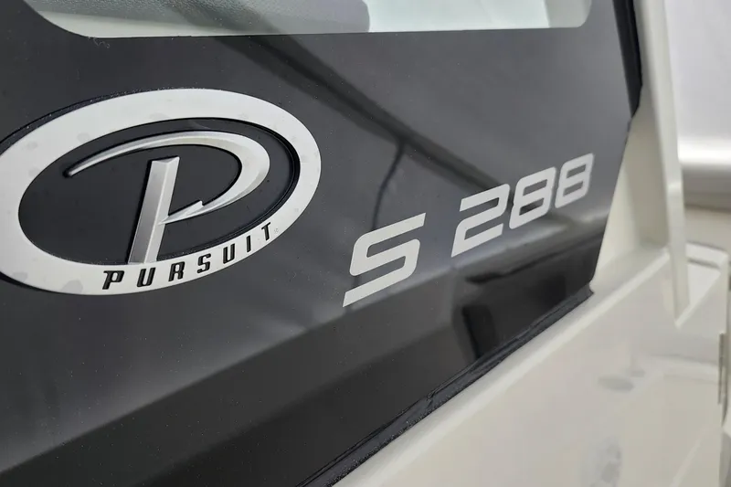 Slide: The Image of 2026 Pursuit S 288 Sport boat dashboard with steering wheel and controls. - 13
