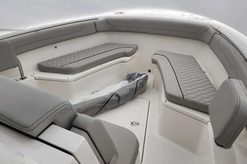 Slide: The Image of Luxurious seating on 2026 Pursuit S 288 Sport boat with quilted upholstery and wooden armrests. - 14