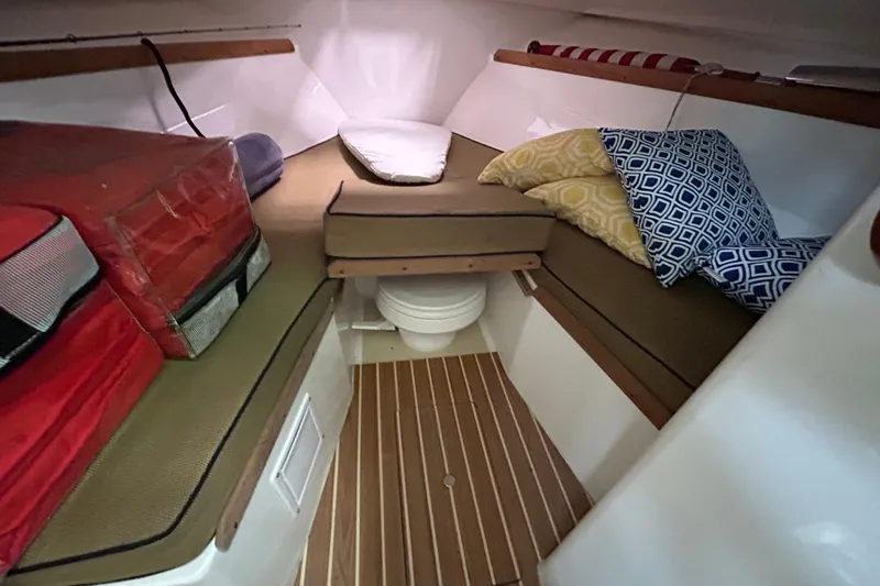 Slide: The Image of 2007 Hunt Yachts Harrier 25 cabin interior with cushions and wooden flooring. - 13