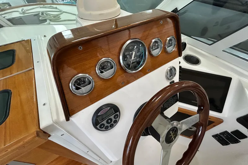 Slide: The Image of 2007 Hunt Yachts Harrier 25 dashboard with wooden accents and steering wheel. - 15