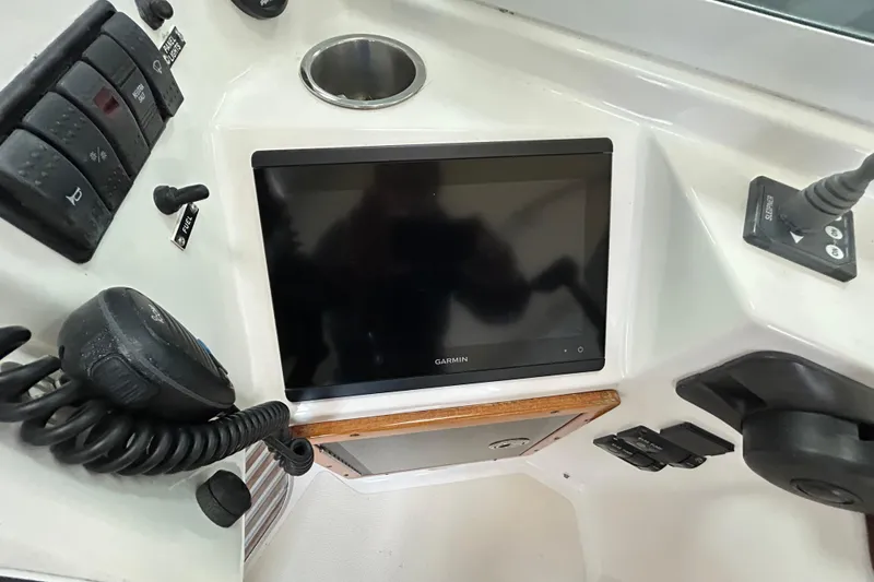 Slide: The Image of 2007 Hunt Yachts Harrier 25 dashboard with Garmin display and control panel. - 16