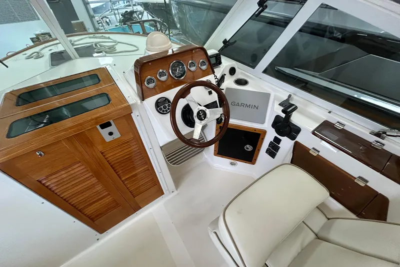 Slide: The Image of 2007 Hunt Yachts Harrier 25 cockpit with wooden dashboard and Garmin navigation system. - 17