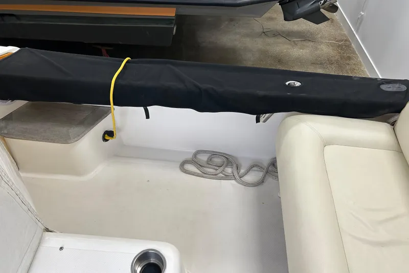 Slide: The Image of 2007 Hunt Yachts Harrier 25 interior with seating and covered equipment. - 20