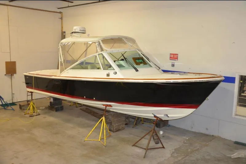 Slide: The Image of 2007 Hunt Yachts Harrier 25 docked, rear view with American flag and "B Positive" name. - 3