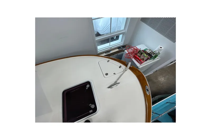 Slide: The Image of 2007 Hunt Yachts Harrier 25 boat deck with hatch and anchor, indoor setting. - 4