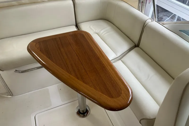 Slide: The Image of Luxurious interior of 2007 Hunt Yachts Harrier 25 with elegant wooden table and white seating. - 9