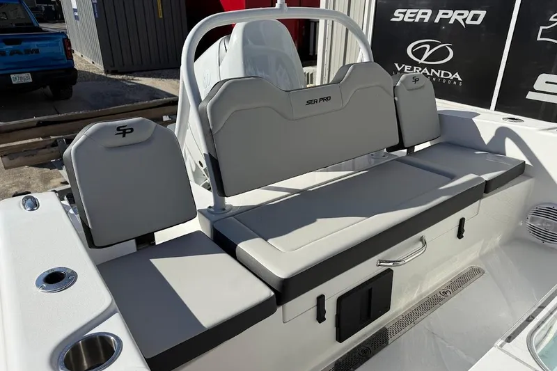 Slide: The Image of 2026 Sea Pro 245FLX Sandbar boat interior with gray seating and storage compartments. - 13