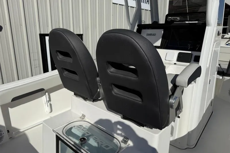 Slide: The Image of 2026 Sea Pro 245FLX Sandbar boat interior with dual black seats and console. - 15