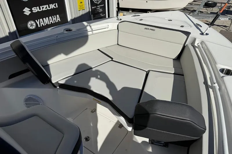 Slide: The Image of 2026 Sea Pro 245FLX Sandbar boat interior with seating and brand logos. - 18
