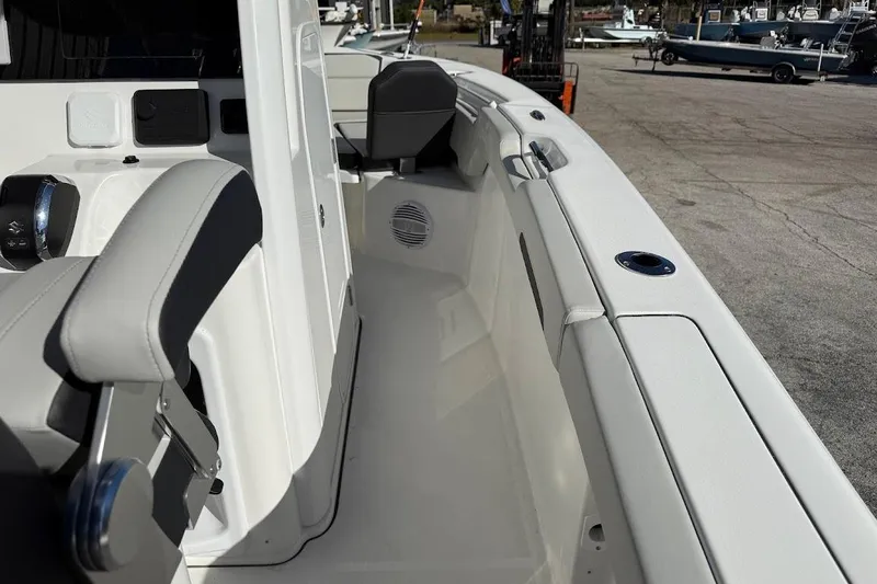 Slide: The Image of 2026 Sea Pro 245FLX Sandbar boat interior with seating and control panel. - 21