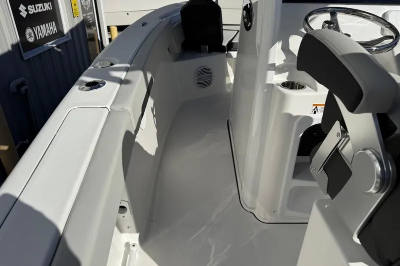 Slide: The Image of 2026 Sea Pro 245FLX Sandbar boat interior with steering wheel and seating. - 22