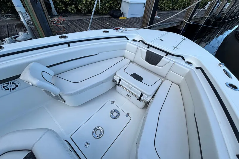 Slide: The Image of 2021 Wellcraft 302 Scarab boat interior with modern helm and seating, docked by waterfront. - 15