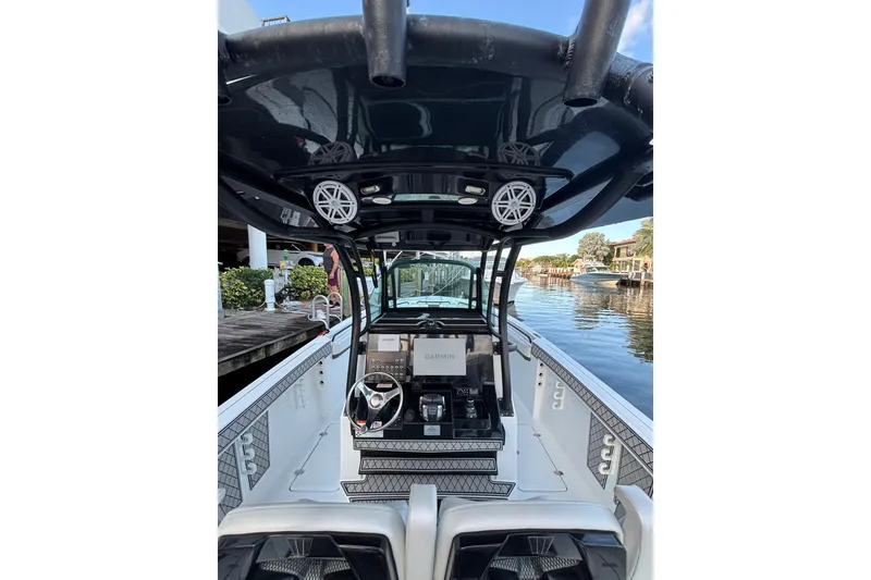 Slide: The Image of 2021 Wellcraft 302 Scarab boat interior with dual sinks and modern dashboard. - 18