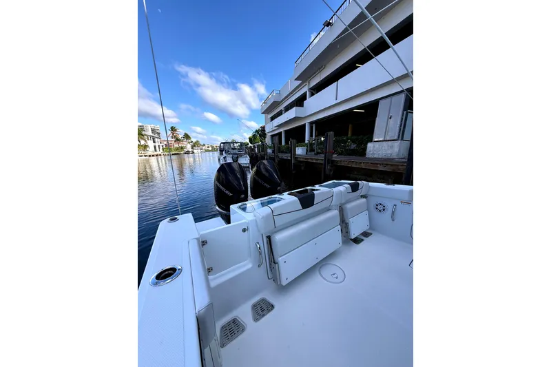 Slide: The Image of 2021 Wellcraft 302 Scarab boat docked by waterfront building. - 21