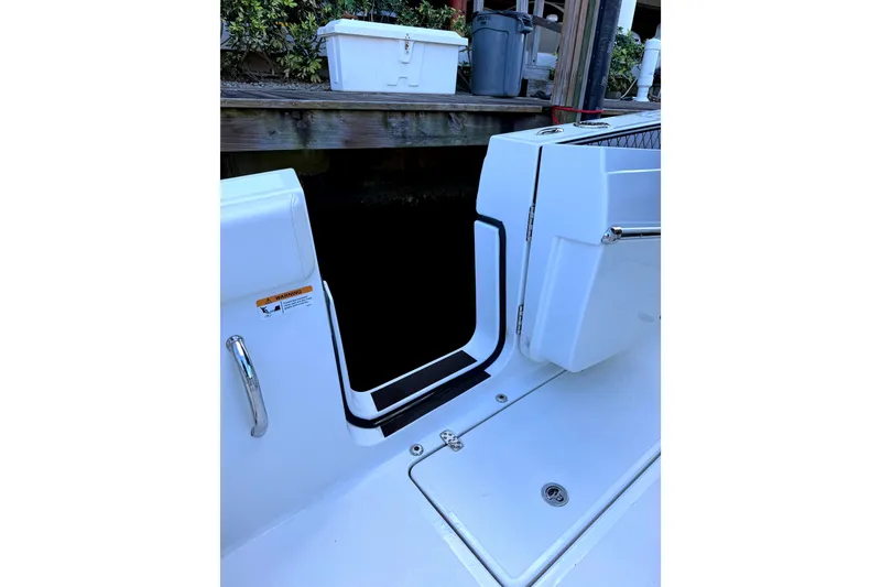 Slide: The Image of 2021 Wellcraft 302 Scarab boat entryway with sleek white design and chrome handle. - 24