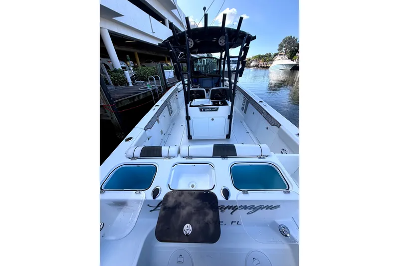 Slide: The Image of 2021 Wellcraft 302 Scarab boat docked, featuring spacious deck and modern amenities. - 25