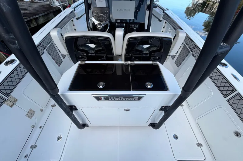 Slide: The Image of 2021 Wellcraft 302 Scarab anchor compartment with open hatch, dockside view. - 9