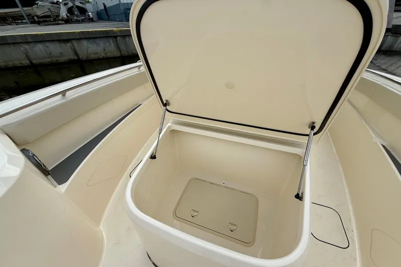 Slide: The Image of Open storage compartment on 2026 Scout 288 LXF boat, showcasing spacious interior design. - 11