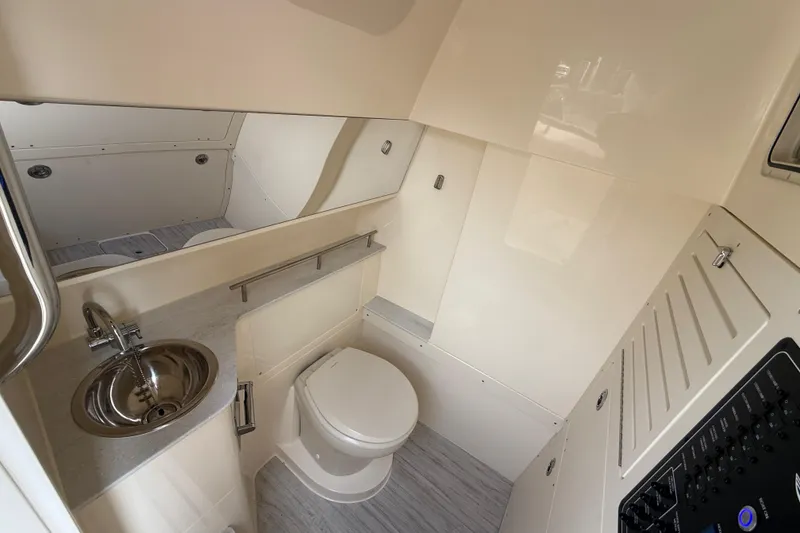 Slide: The Image of 2026 Scout 288 LXF boat interior bathroom with modern fixtures and sleek design. - 18