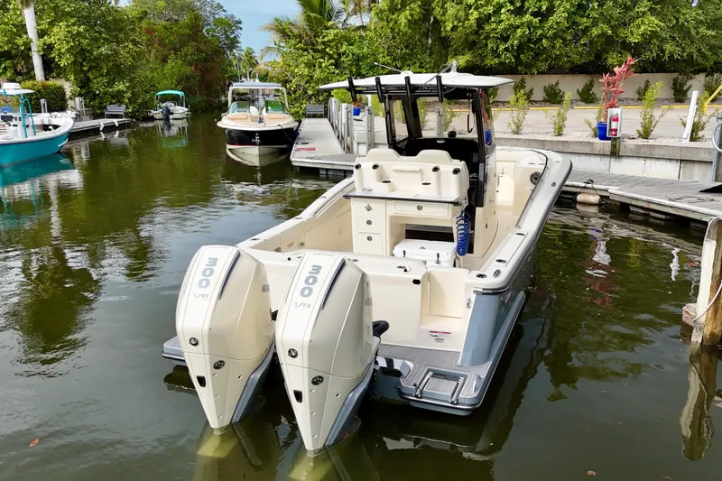 Slide: The Image of 2026 Scout 288 LXF boat docked with twin Mercury 300 V8 engines. - 4