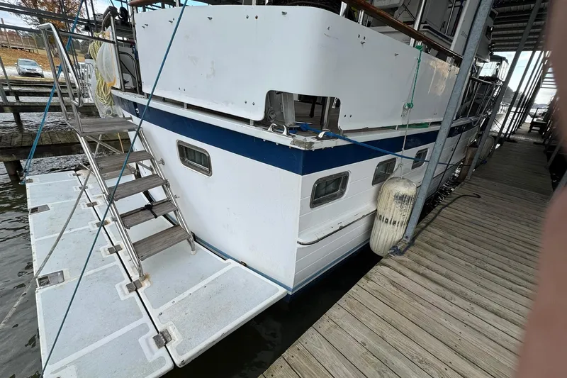 Slide: The Image of 1991 DeFever 44 yacht docked with boarding ladder and fender visible. - 11