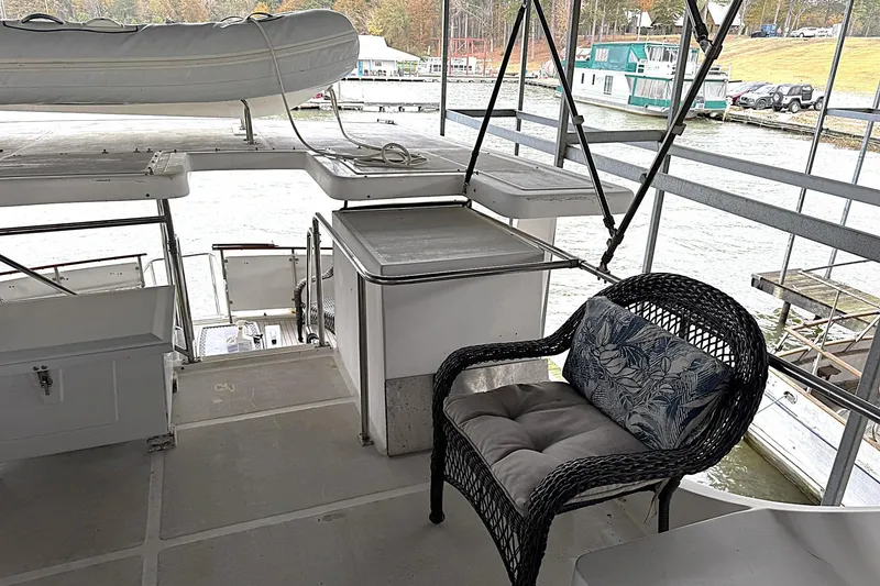 Slide: The Image of 1991 DeFever 44 yacht deck with wicker chair and inflatable boat. - 26