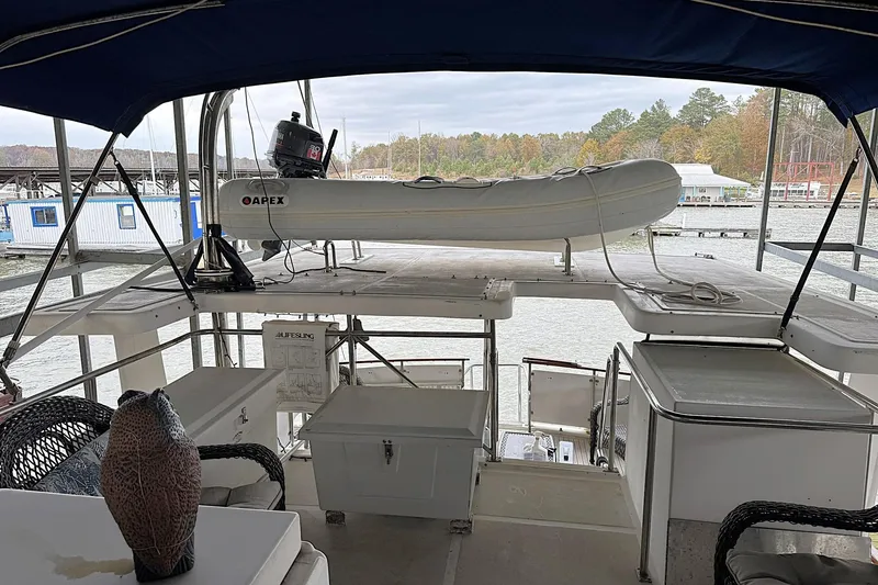 Slide: The Image of 1991 DeFever 44 yacht deck with dinghy and marina view. - 28