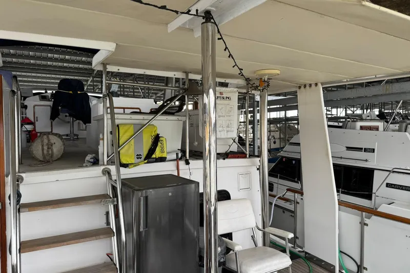 Slide: The Image of 1991 DeFever 44 yacht interior with seating, stairs, and safety equipment. - 29
