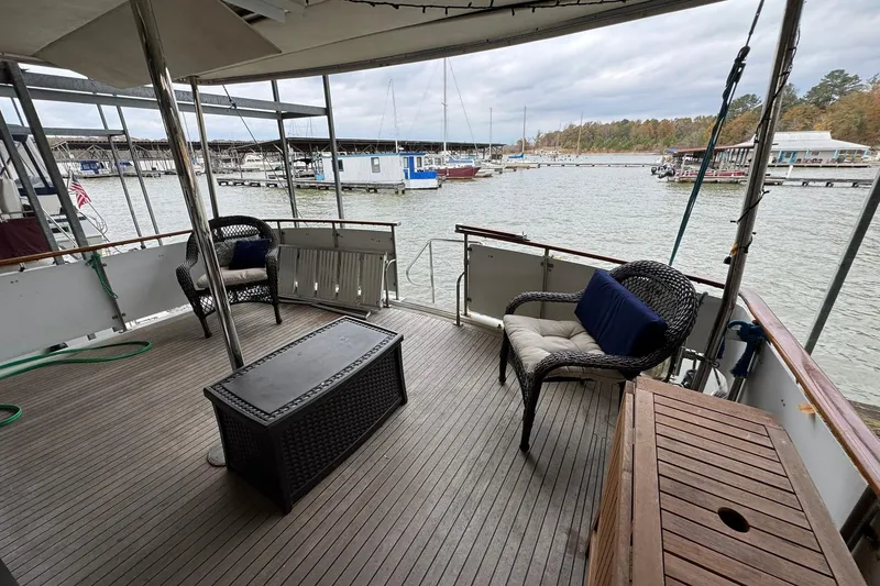 Slide: The Image of Spacious deck of 1991 DeFever 44 yacht with wicker furniture and marina view. - 33