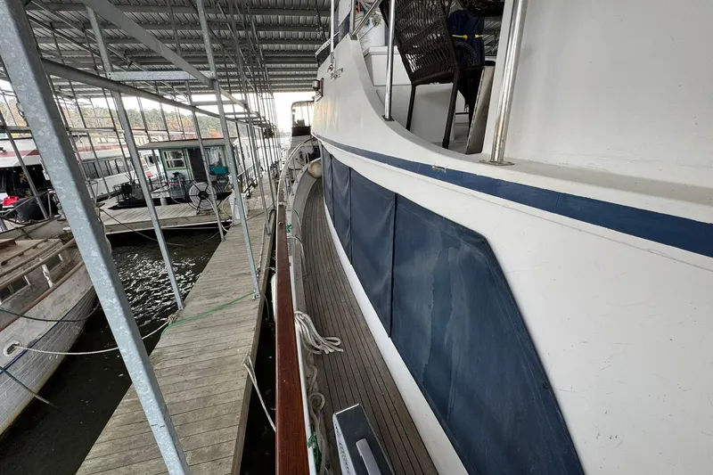 Slide: The Image of 1991 DeFever 44 yacht docked in a covered marina, side view. - 34