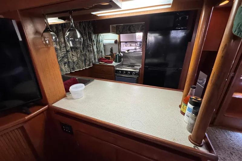Slide: The Image of Interior of 1991 DeFever 44 yacht kitchen with counter, stove, and refrigerator. - 39