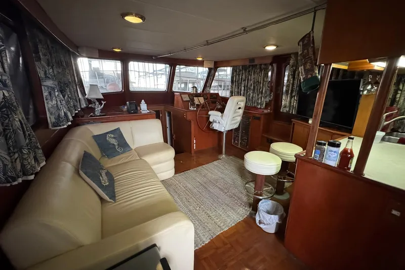 Slide: The Image of Interior of 1991 DeFever 44 yacht with cozy seating and nautical decor. - 41