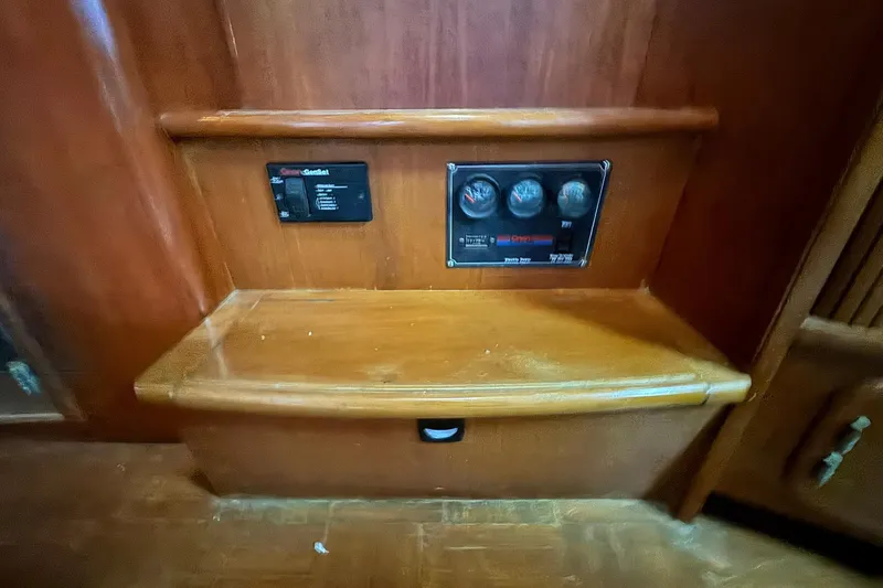 Slide: The Image of Control panel on 1991 DeFever 44 yacht, featuring gauges and wooden interior. - 46