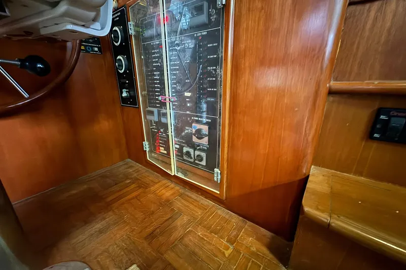 Slide: The Image of 1991 DeFever 44 yacht interior with control panel and wooden flooring. - 47