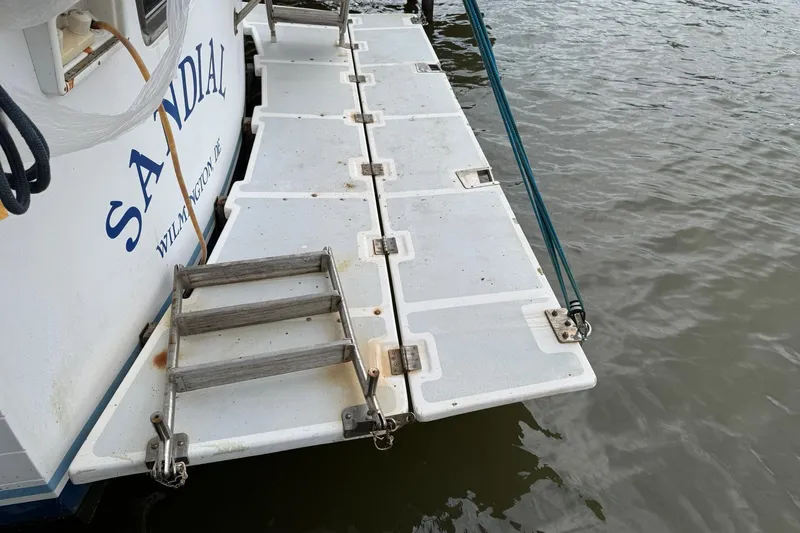 Slide: The Image of Swim platform of 1991 DeFever 44 boat with ladder, docked on water. - 5