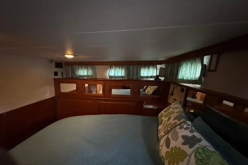 Slide: The Image of Cozy cabin interior of 1991 DeFever 44 yacht with wooden accents and green curtains. - 56