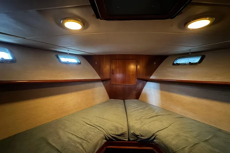 Slide: The Image of Cozy cabin interior of 1991 DeFever 44 yacht with twin beds and wooden accents. - 58