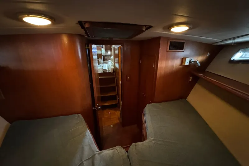 Slide: The Image of 1991 DeFever 44 yacht interior cabin with twin beds and wooden finish. - 63