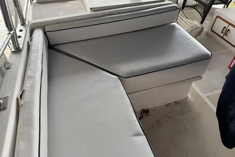 Slide: The Image of 1991 DeFever 44 boat interior with cushioned seating area. - 69