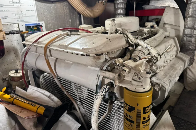 Slide: The Image of Engine room of a 1991 DeFever 44 yacht, featuring a detailed view of the engine components. - 72