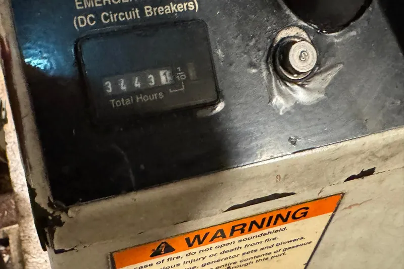 Slide: The Image of Close-up of a 1991 DeFever 44 engine hour meter showing 3243.1 hours with warning label. - 77